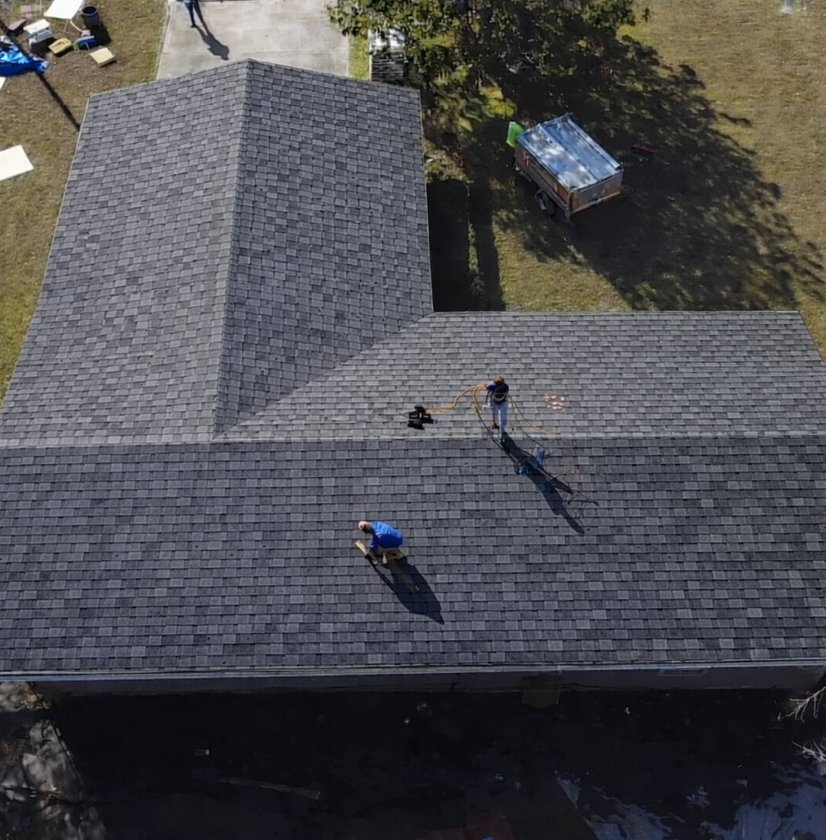 Cash Construction crew installing shingles on a hip roof in Madison, MS