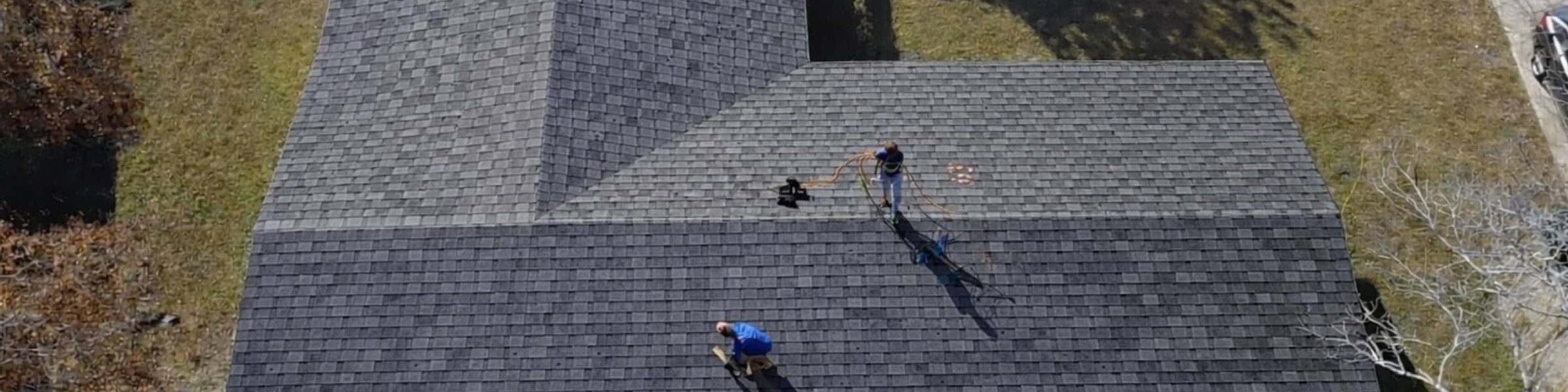 Cash Construction crew installing shingles on a hip roof in Madison, MS