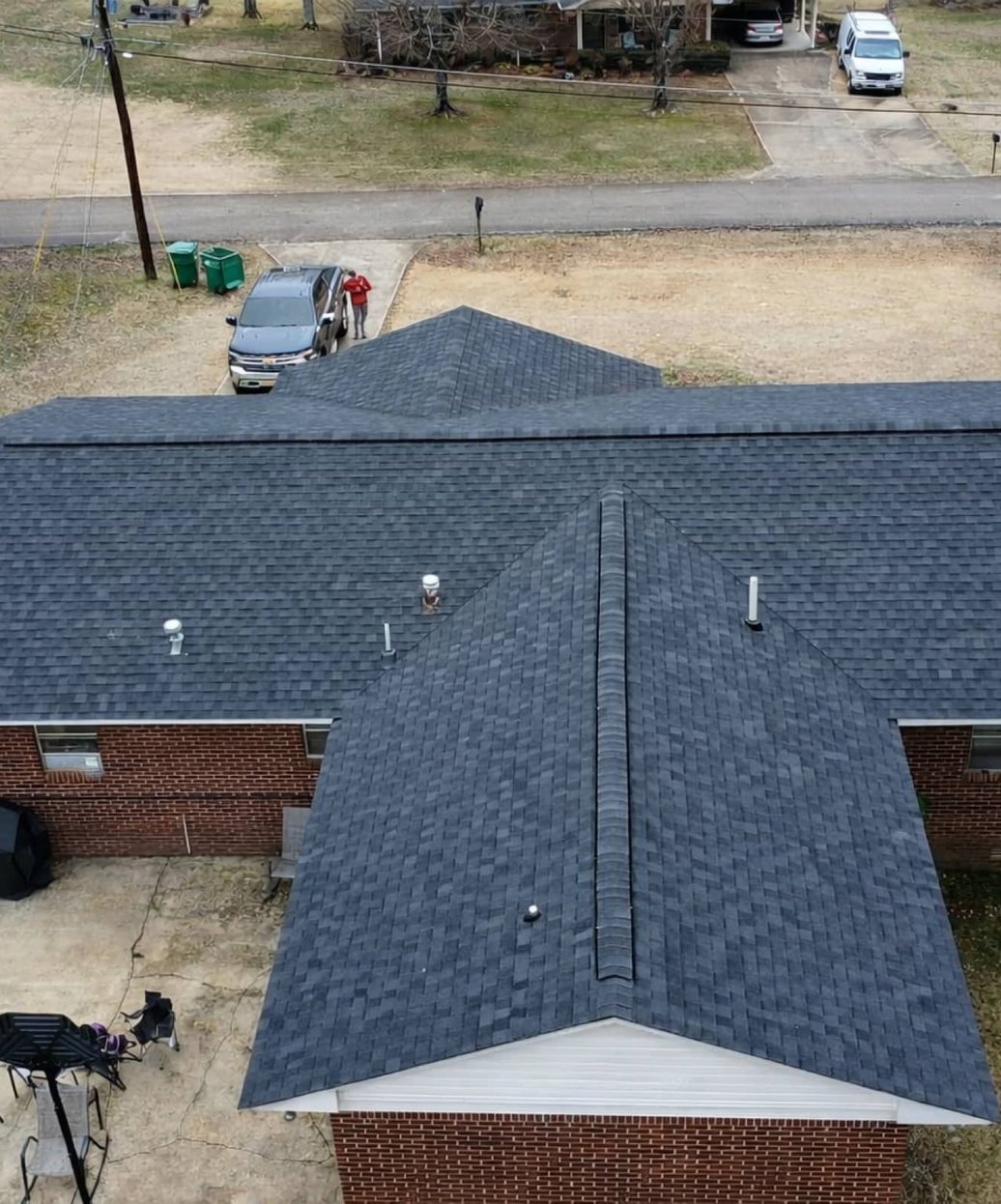 Wood privacy fence and backyard patio behind a brick home in Madison, MS