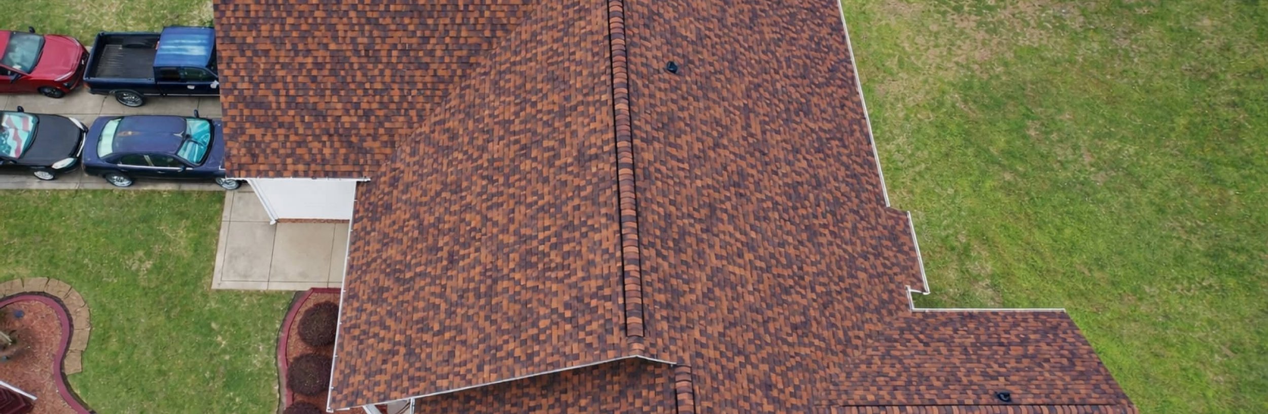 Top-down drone view of a new brown architectural shingle roof in Madison, MS