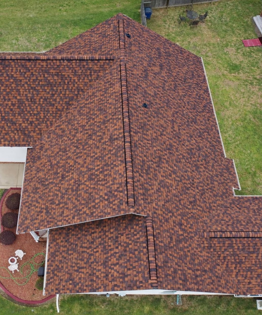 Top-down drone view of a new brown architectural shingle roof in Madison, MS
