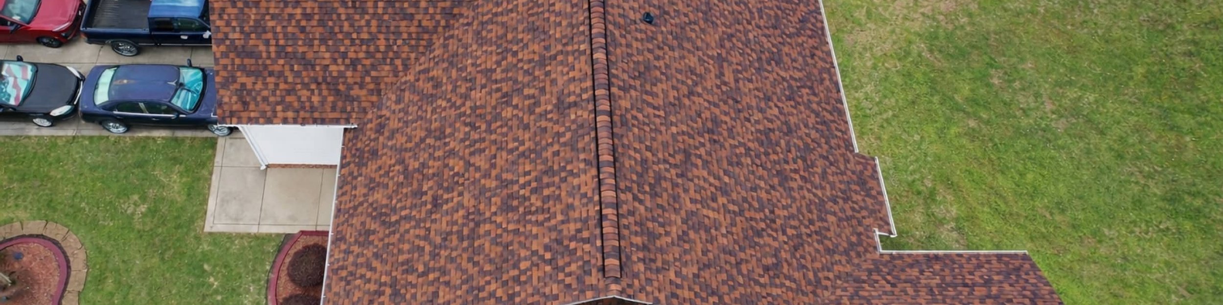 Top-down drone view of a new brown architectural shingle roof in Madison, MS