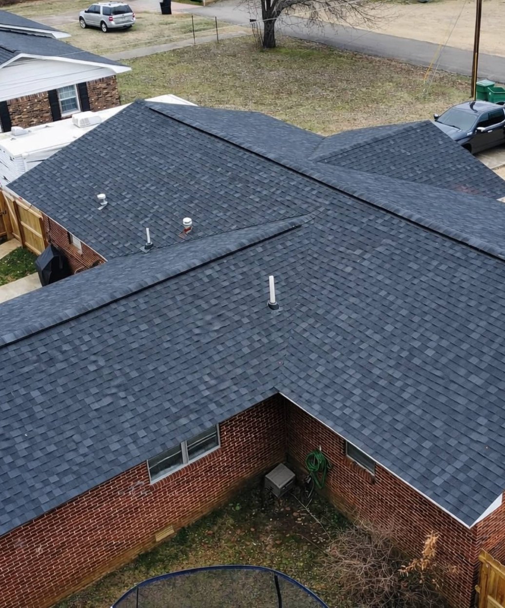 Drone view of a completed charcoal shingle roof on a brick home in Madison, MS