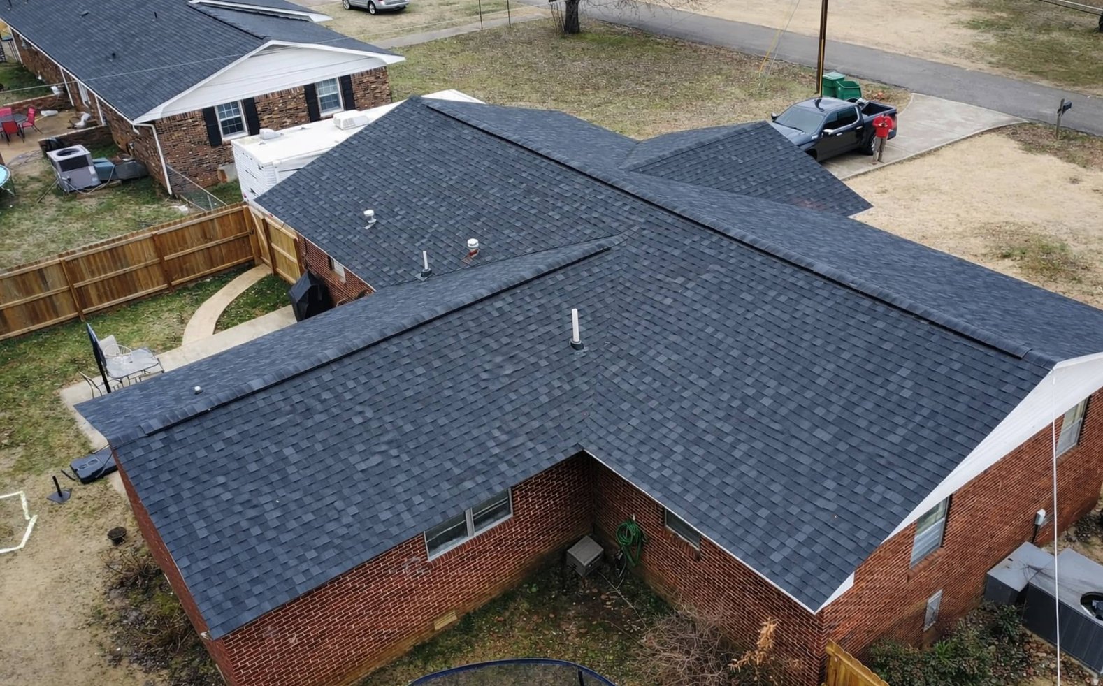Drone view of a completed charcoal shingle roof on a brick home in Madison, MS
